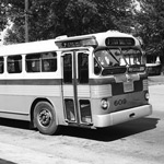1950s bus pulling away from the curb