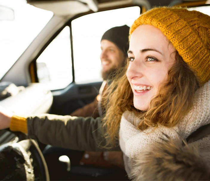Woman driving in winter with stocking hat on