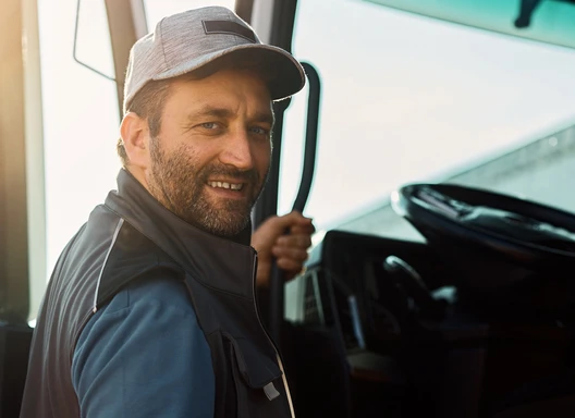Man climbing into large truck