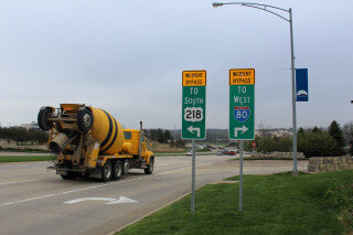 A cement truck preparing to turn onto an incident bypass route on a highway