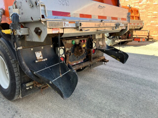 a custom mudflap on the back of a salt truck